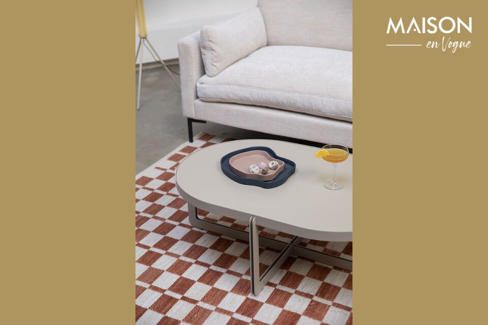 The beige steel oval coffee table brings a touch of minimalist elegance to any living space