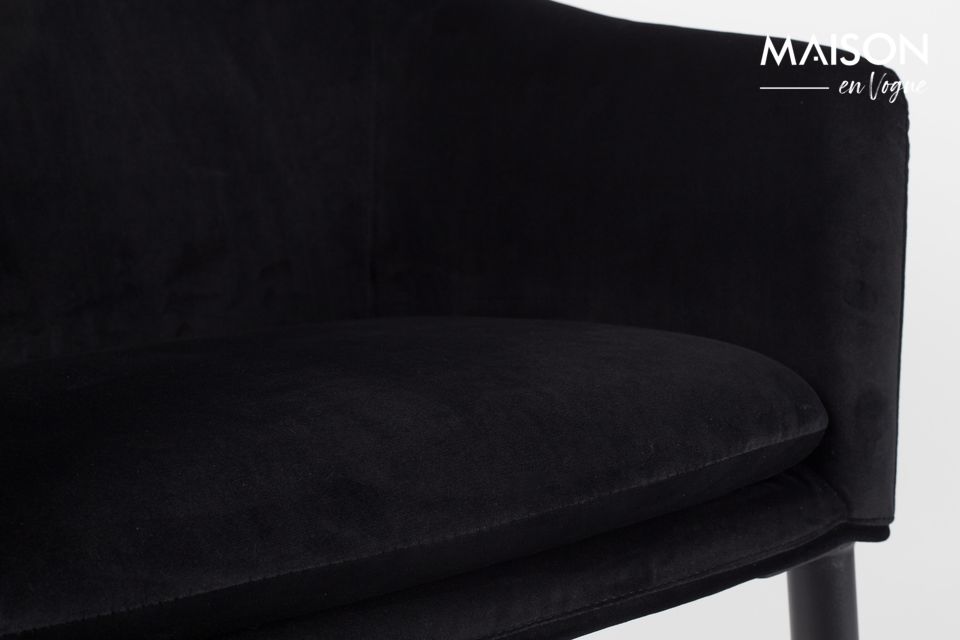 Four thick legs support a soft seat covered with a velvety-looking fabric