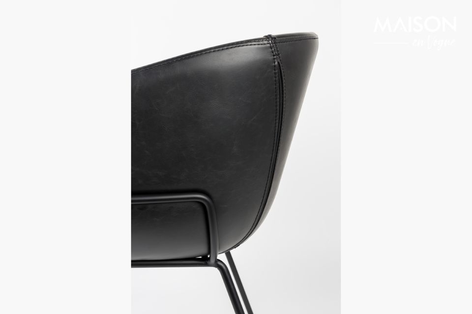 Its black steel frame runs along the sides of the seat to hold a ribbed leather seat