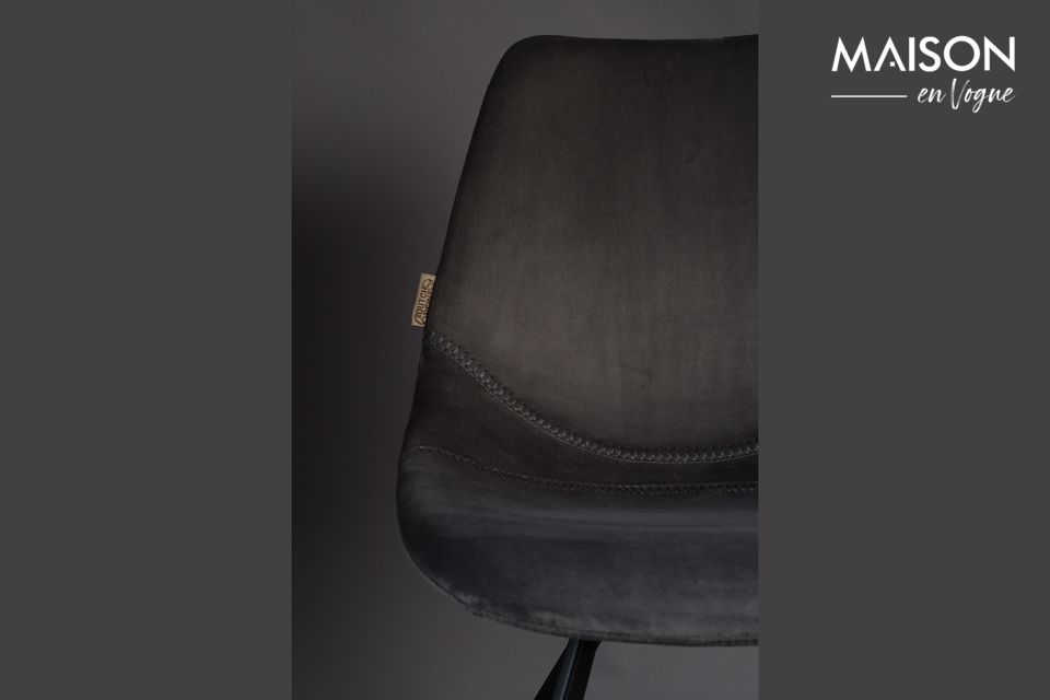 The seat and backrest are one under their delicate envelope of shimmering grey velvet