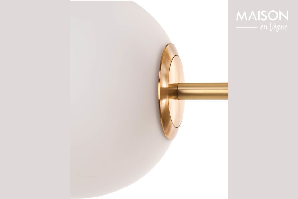 It features an elegant cylindrical base made of black marble that extends into a brushed brass