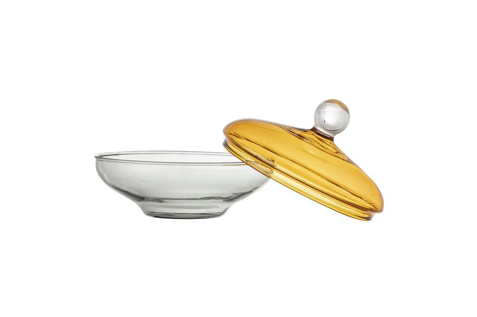 The Danni jar with lid from Bloomingville is a delicate glass piece with a bright yellow tinted lid