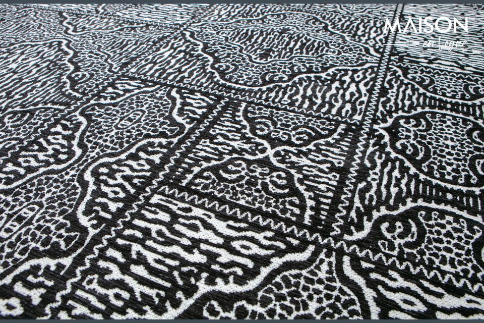 This large black and white fabric rug Renna features aesthetic, complex and elaborate patterns