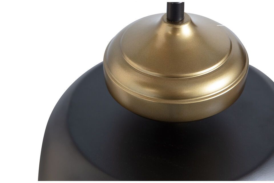 The lampshade has a rather simple design but the combination of matte black metal and antique brass