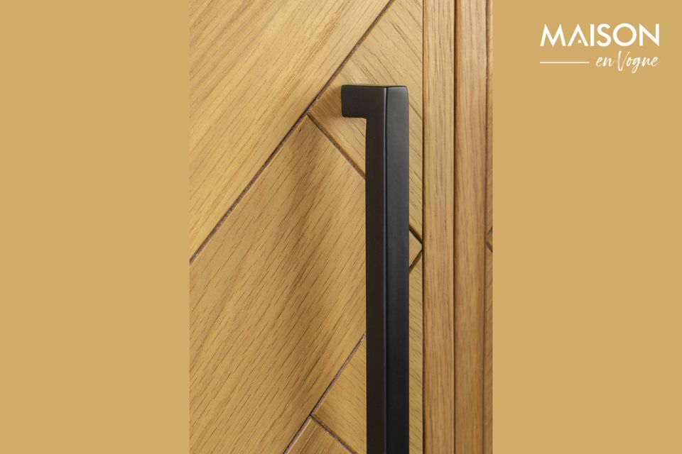 Its two doors are adorned with a wooden decoration and fine black brass handles