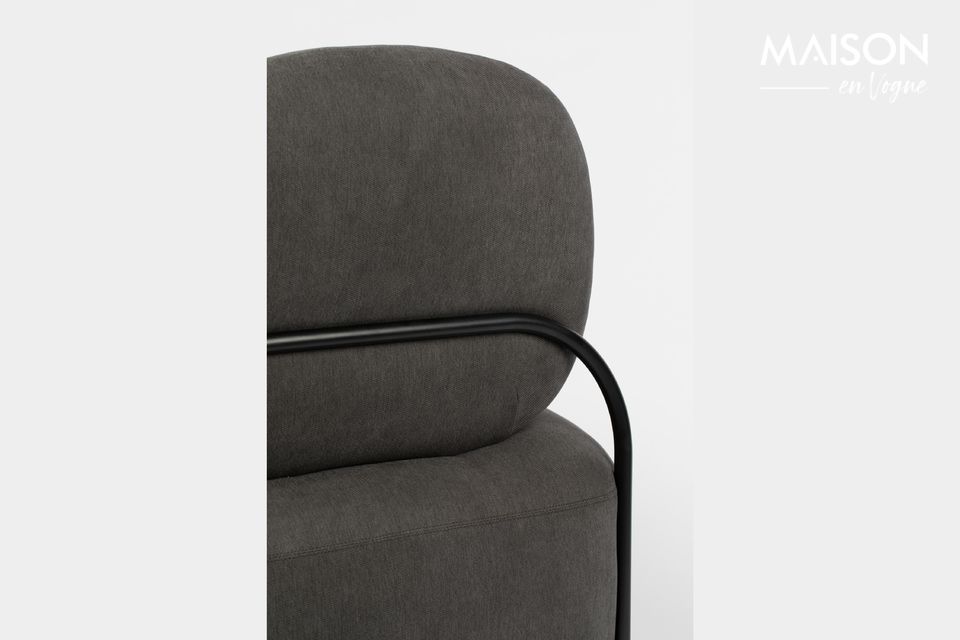 This Polly Grey lounge chair by White Label Living has a slightly curved profile that underlines its