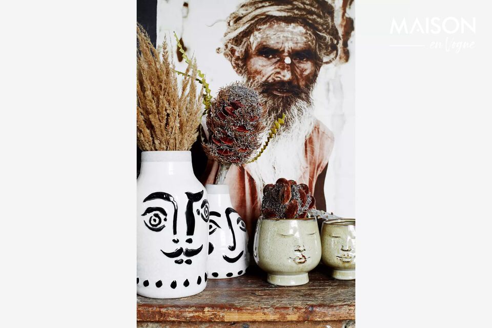 This vase features a white colour, accented by bold black lines that create a minimalist face