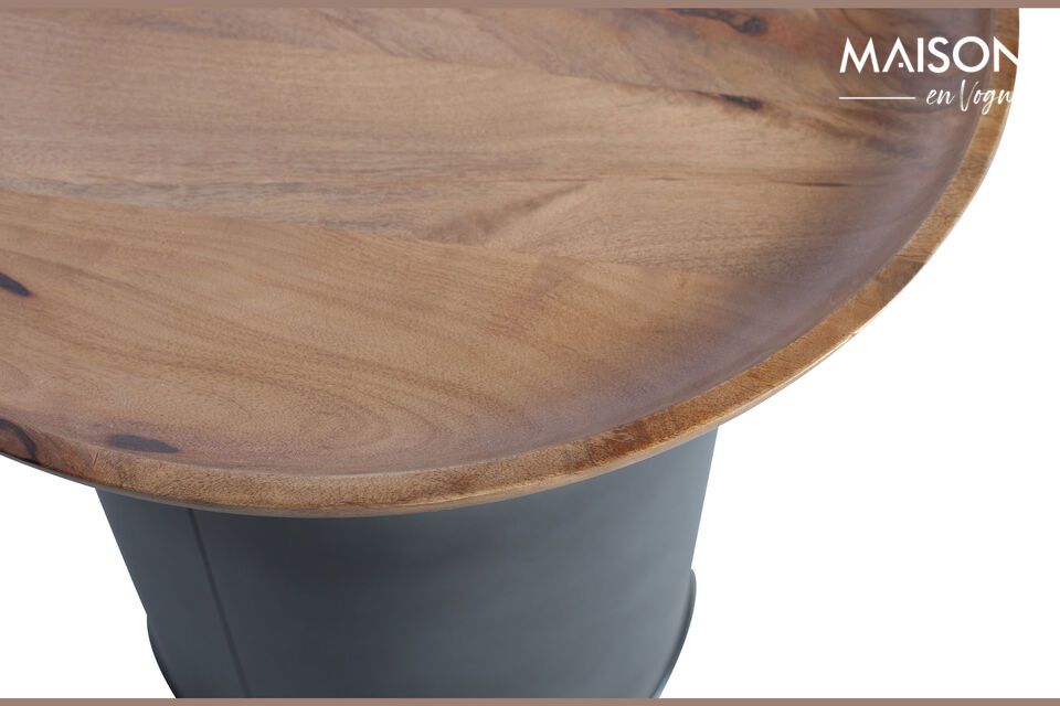 The metal base is reminiscent of the tares used to balance scales while the mango wood top