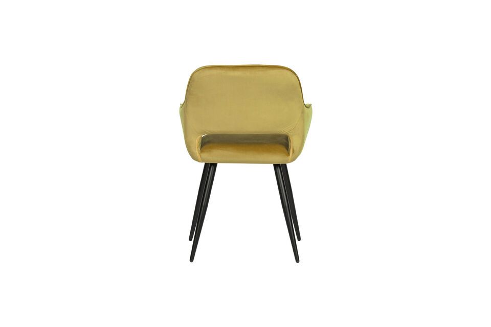 It is upholstered in an elegant velvet in a trendy buff yellow color